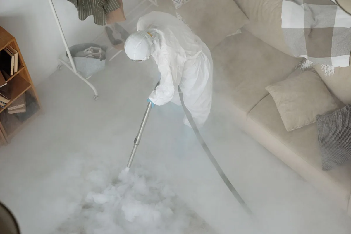 Biohazard cleanup technician in protective equipment, Ely, IA